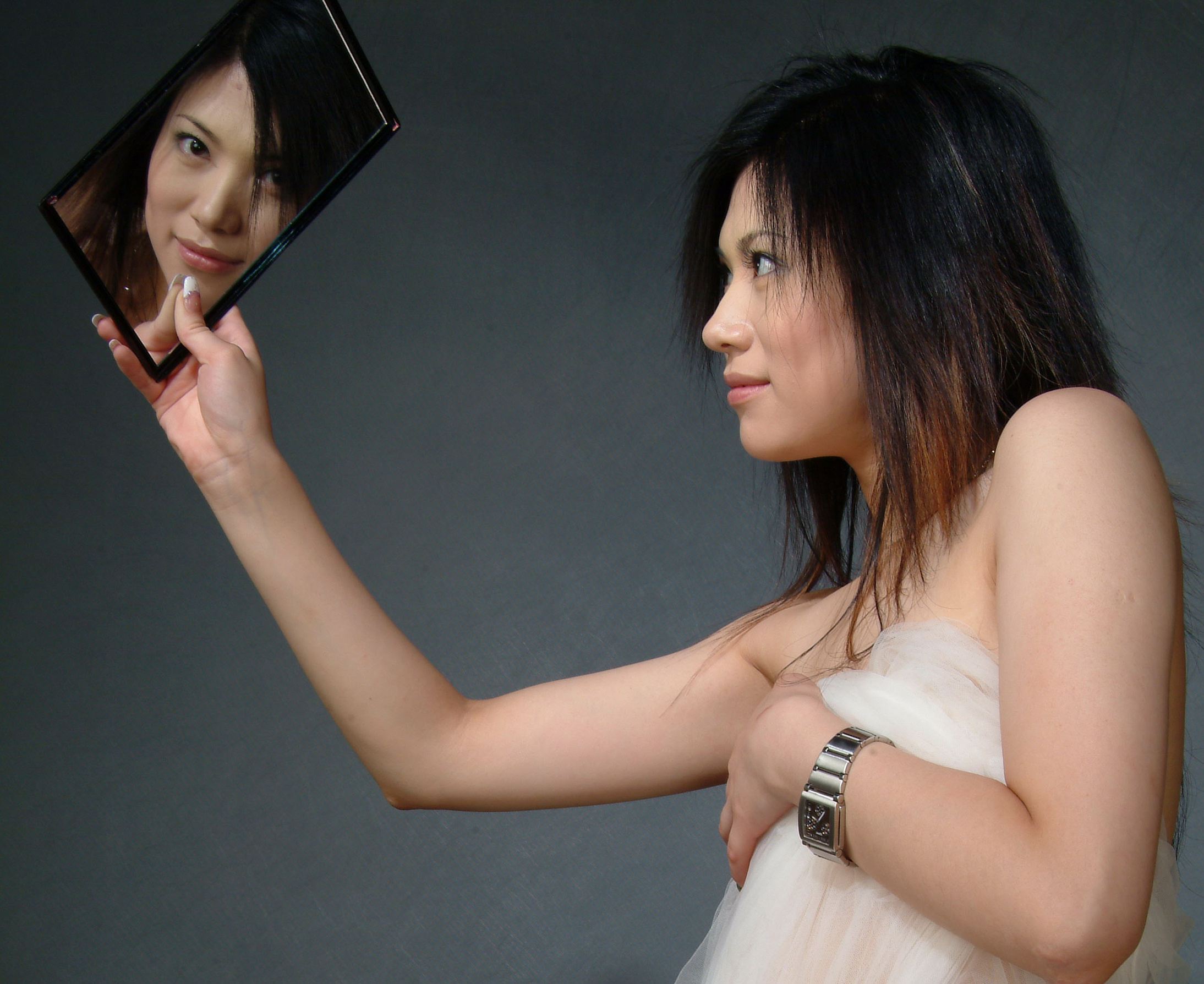 female looking at herself in a mirror